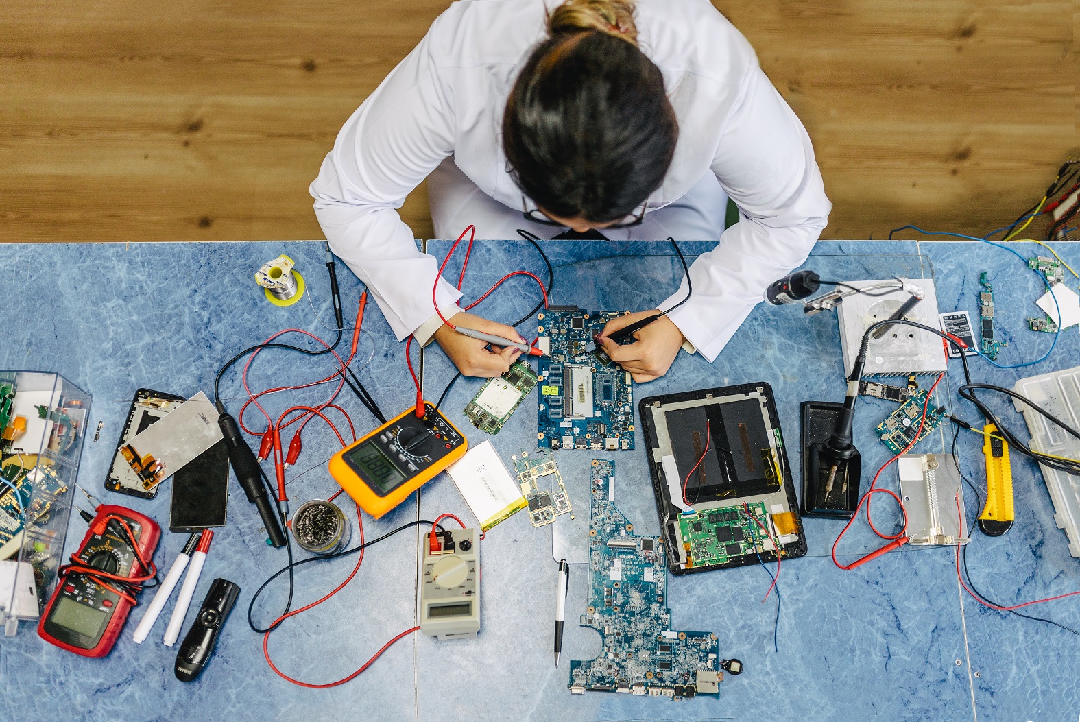 Overhead view of a young woman at a workbench