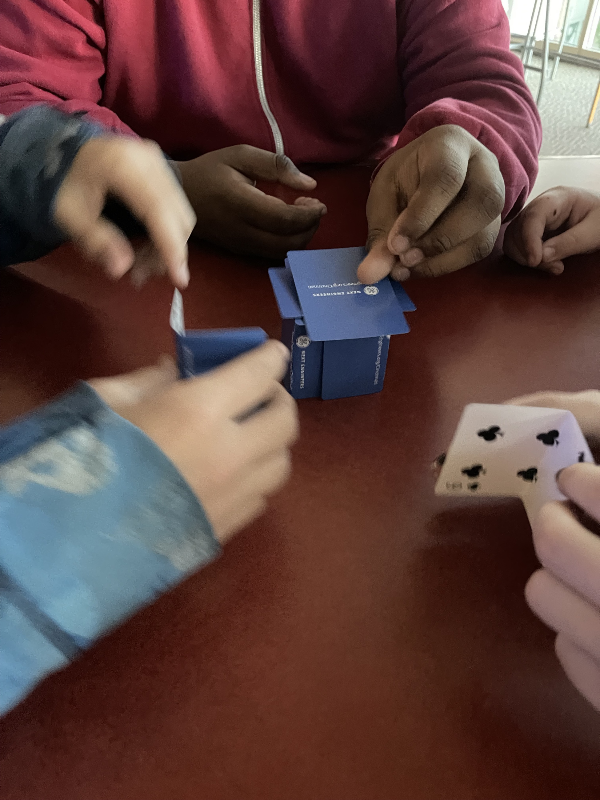 Students building structures using cards