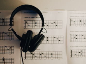 Headset on Sheet Music - Credit Kelly Sikkema Unsplash