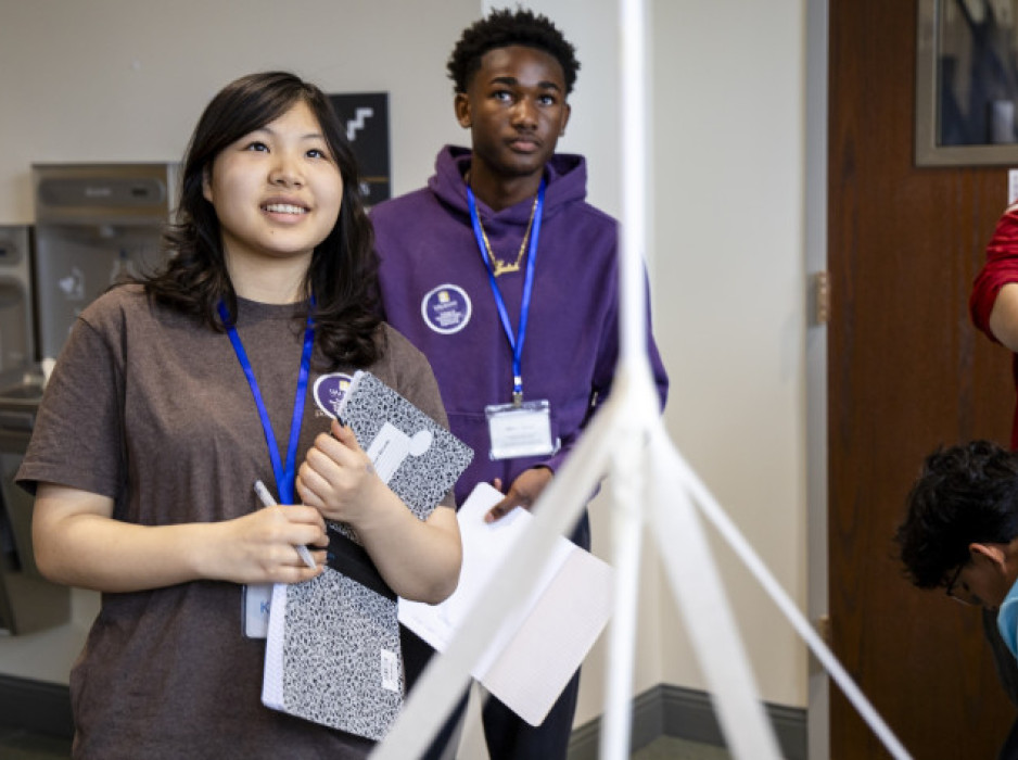 Kathryn Payne and Judah Thigpen look up at their standing tower. 